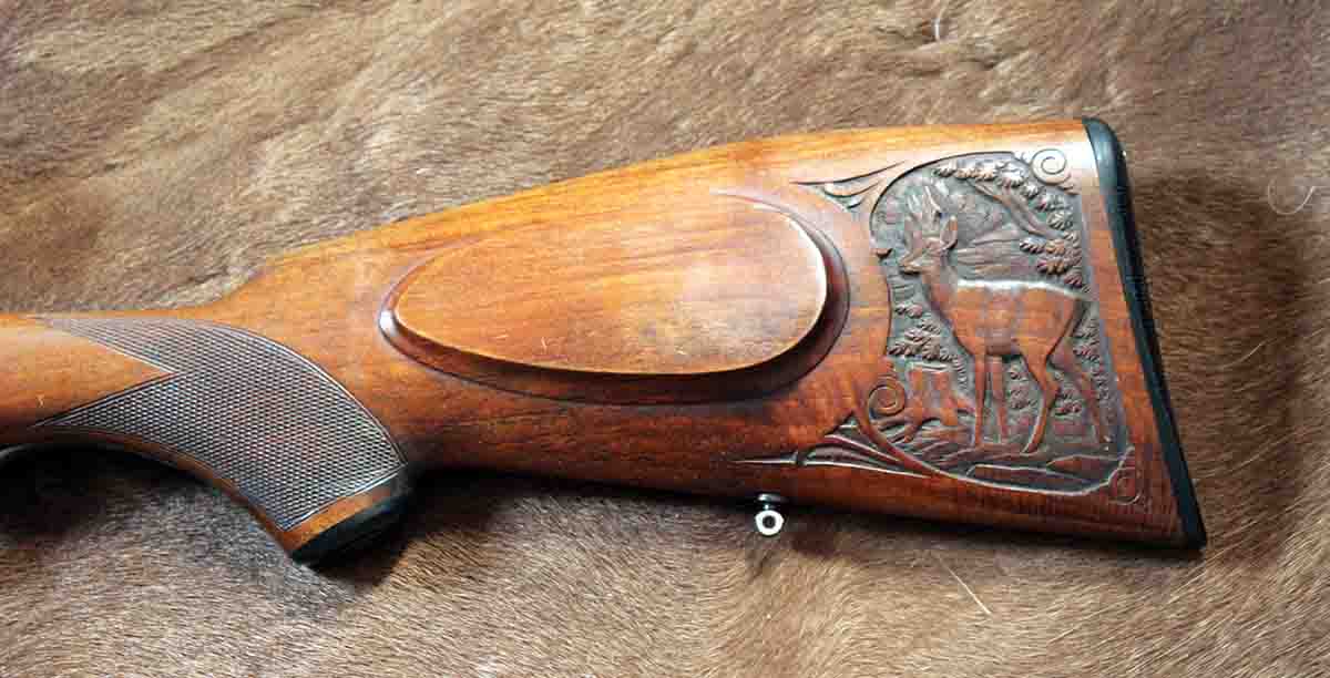 Many German break-action guns have game scenes engraved on the action, but this one has one carved in the buttstock.